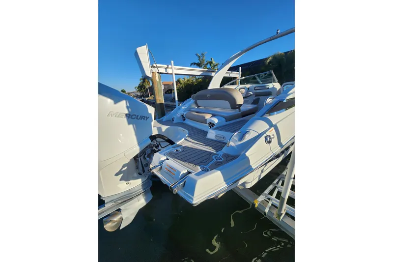 Slide: The Image of 2020 Crownline Eclipse E255 XS boat with Mercury engine, docked under clear blue sky. - 31