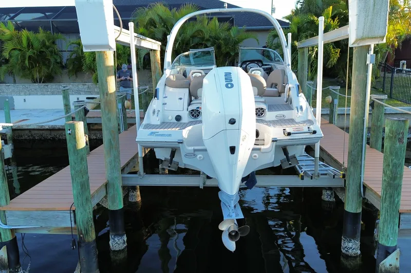 Slide: The Image of 2020 Crownline Eclipse E255 XS boat docked on a lift, rear view. - 4