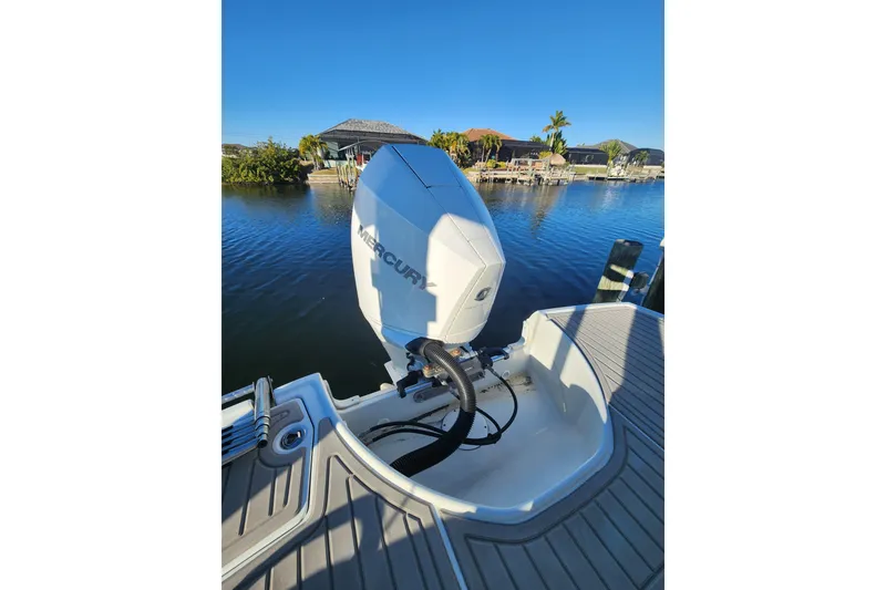 Slide: The Image of 2020 Crownline Eclipse E255 XS boat with Mercury outboard engine on a sunny day. - 5
