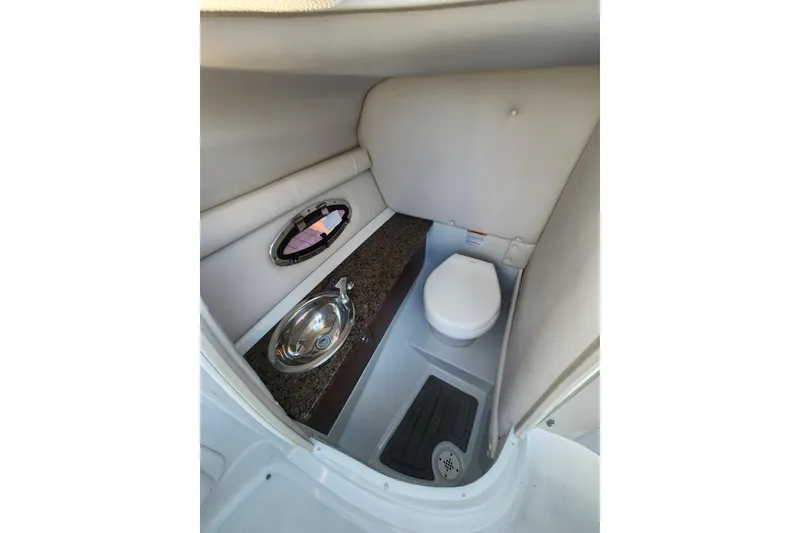 Slide: The Image of 2020 Crownline Eclipse E255 XS boat interior bathroom with sink and toilet. - 6