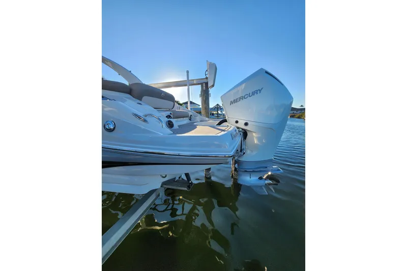 Slide: The Image of 2020 Crownline Eclipse E255 XS boat with Mercury outboard engine on water. - 8