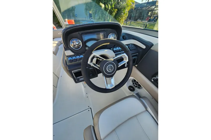 Slide: The Image of 2020 Crownline Eclipse E255 XS boat cockpit with steering wheel and dashboard controls. - 9