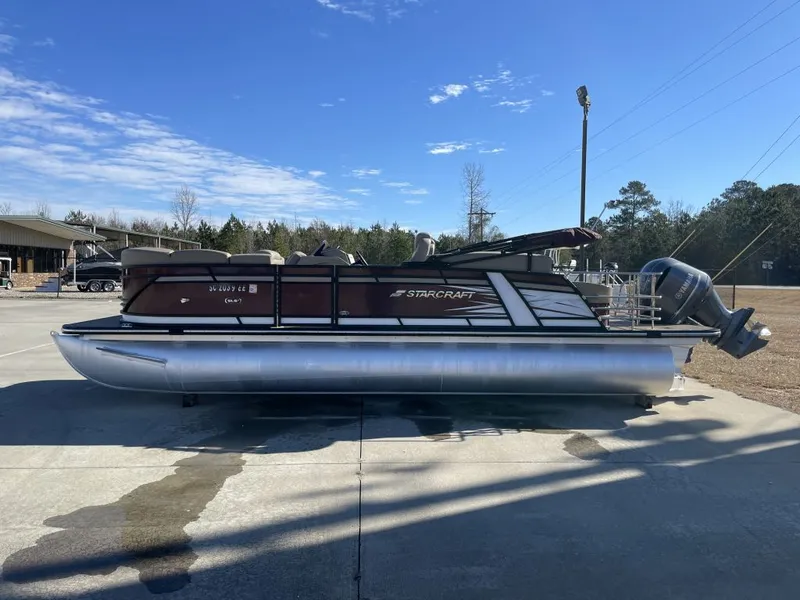 Slide: The Image of 2024 Starcraft SLS 3 Q DH pontoon boat on parking lot. - 3