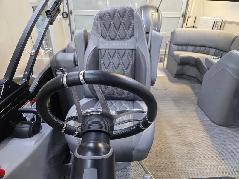 Slide: The Image of Interior of 2022 Bennington 25RFB with steering wheel and seating. - 19