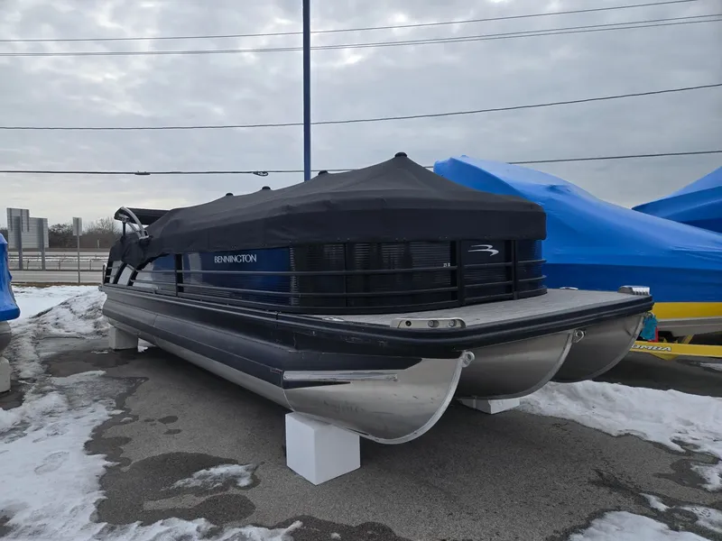 Slide: The Image of 2022 Bennington 25RFB pontoon boat covered outdoors. - 2