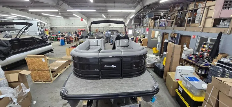 Slide: The Image of 2022 Bennington 25RFB pontoon boat in a workshop. - 25