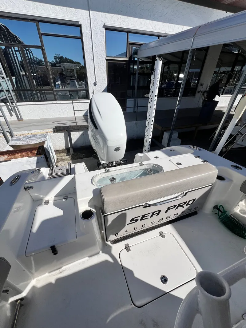 Slide: The Image of 2021 Sea Pro 239 DLX boat at dock with outboard motor. - 11