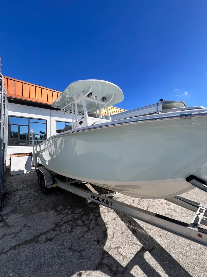 Slide: The Image of 2021 Sea Pro 239 DLX boat on trailer outside building. - 2