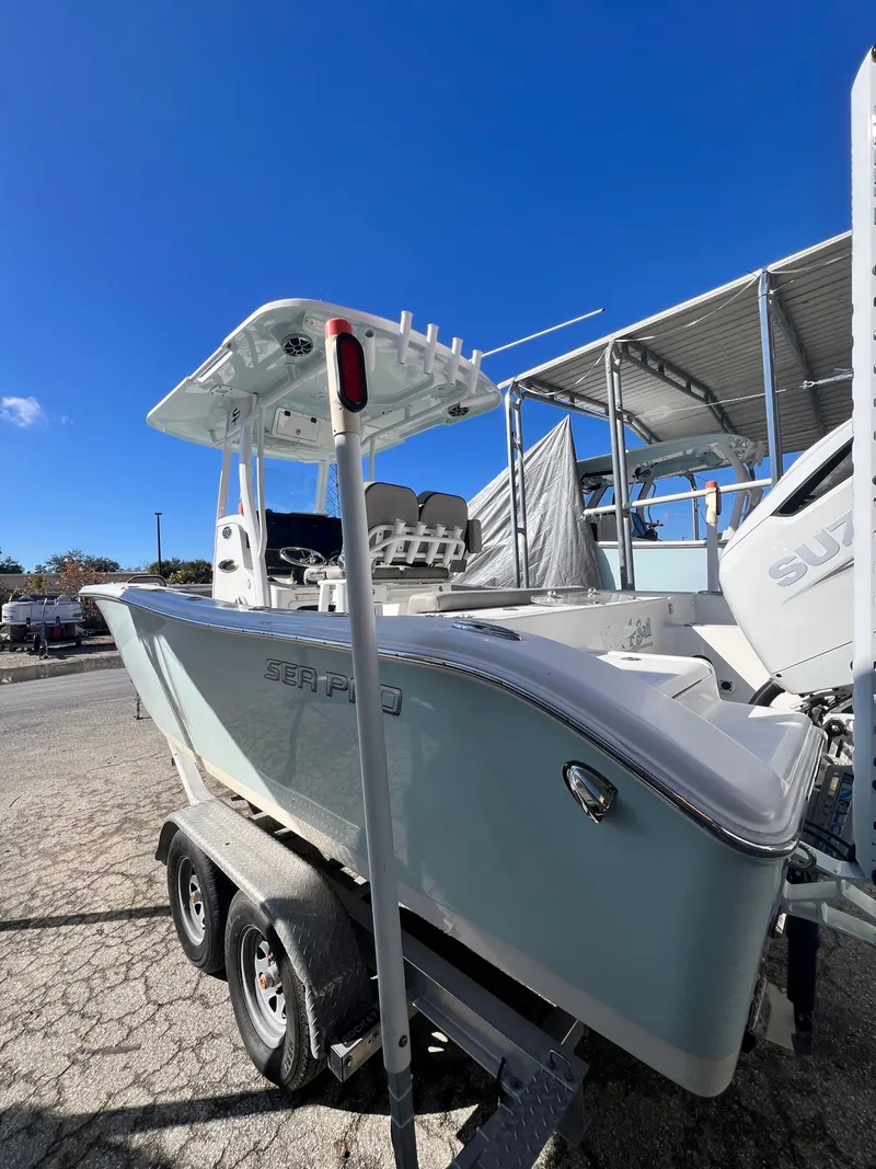 Slide: The Image of 2021 Sea Pro 239 DLX boat on trailer under blue sky. - 3