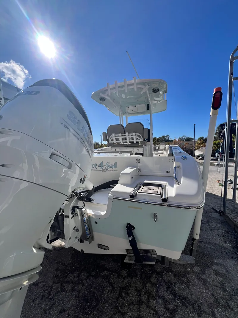 Slide: The Image of 2021 Sea Pro 239 DLX boat with outboard motor under sunny sky. - 6