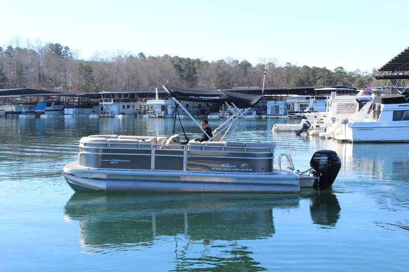 The Image of 2025 Tracker PB 20 DLX pontoon boat on calm water. - 1