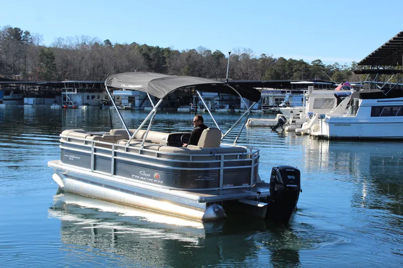Slide: The Image of 2025 Tracker PB 20 DLX pontoon boat on calm water. - 3
