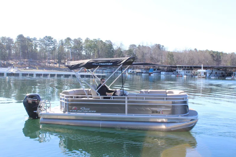 Slide: The Image of 2025 Tracker PB 20 DLX pontoon boat on calm lake. - 6
