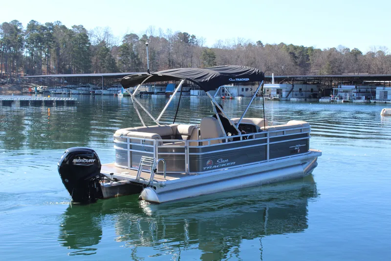 Slide: The Image of 2025 Tracker PB 20 DLX pontoon boat on calm lake. - 7