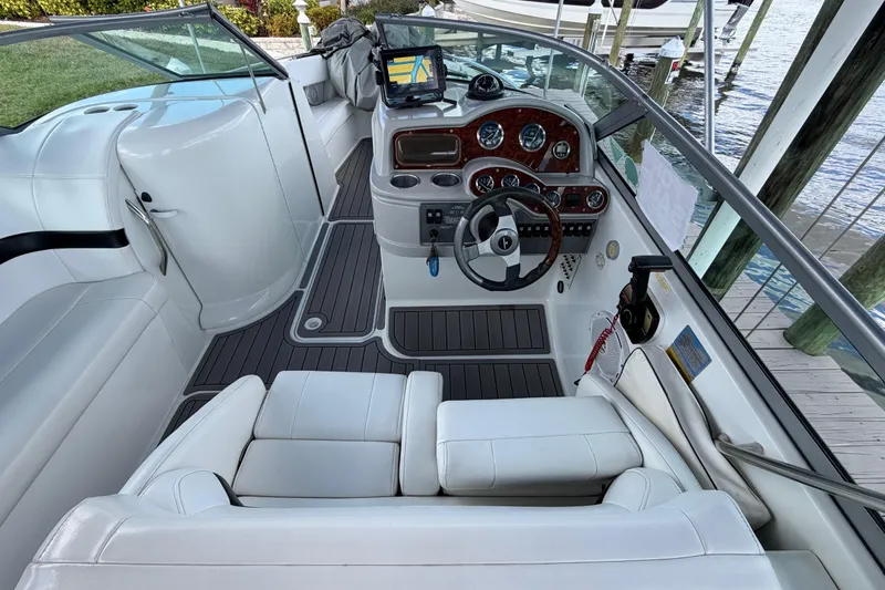 Slide: The Image of 2004 Formula 260 Bowrider boat interior with steering wheel and dashboard view. - 10