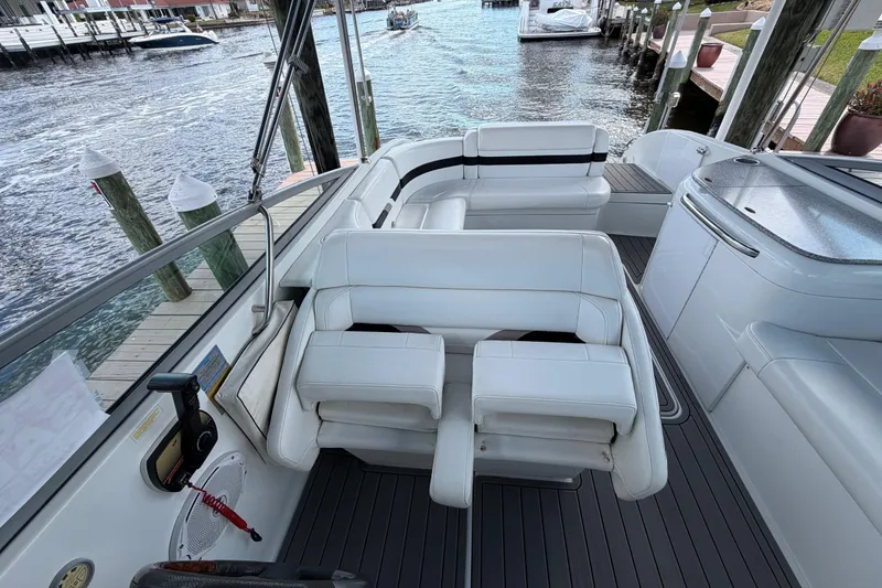 Slide: The Image of 2004 Formula 260 Bowrider boat interior with white seating and waterfront view. - 15