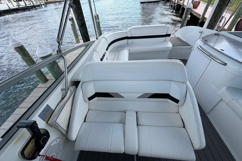 Slide: The Image of 2004 Formula 260 Bowrider interior with white seating, dockside view. - 16