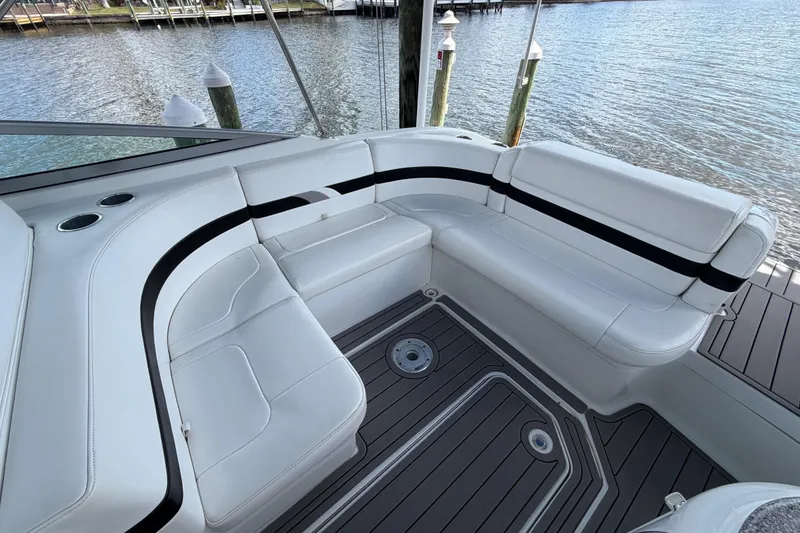 Slide: The Image of 2004 Formula 260 Bowrider boat interior with white seating and water view. - 18