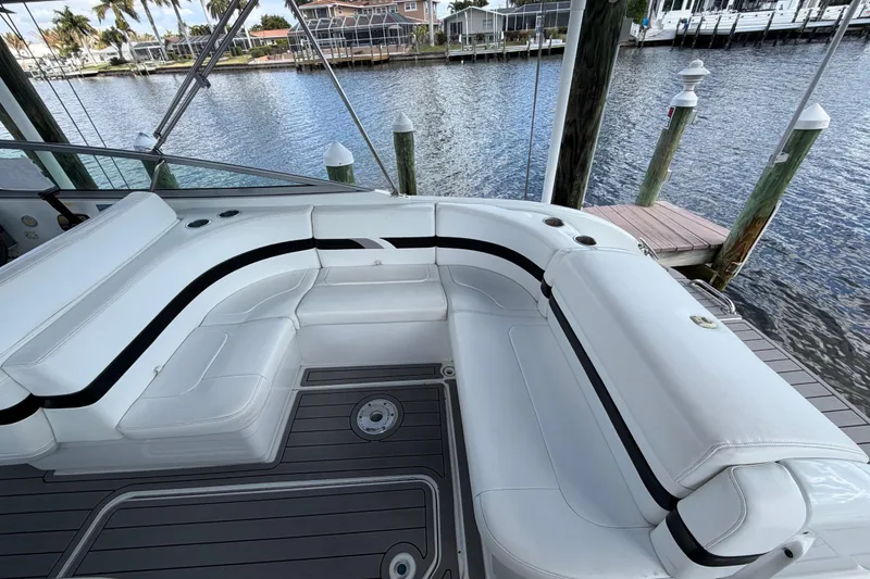 Slide: The Image of 2004 Formula 260 Bowrider boat with white seating, docked by a waterfront. - 19