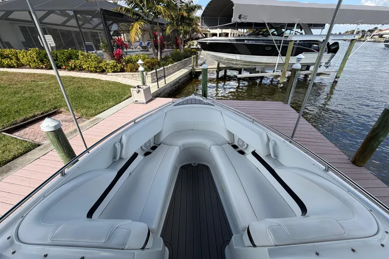 Slide: The Image of 2004 Formula 260 Bowrider boat docked by a scenic waterfront. - 22