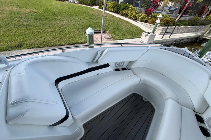 Slide: The Image of 2004 Formula 260 Bowrider boat interior with white seating and gray flooring. - 23