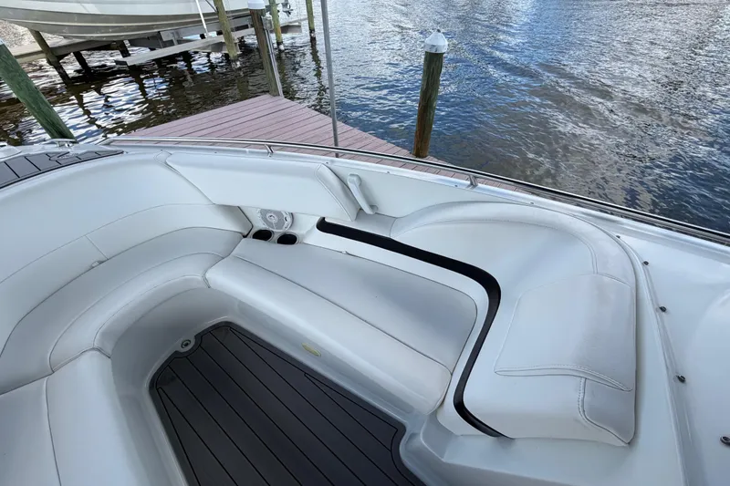 Slide: The Image of 2004 Formula 260 Bowrider boat interior with white seating and water view. - 24