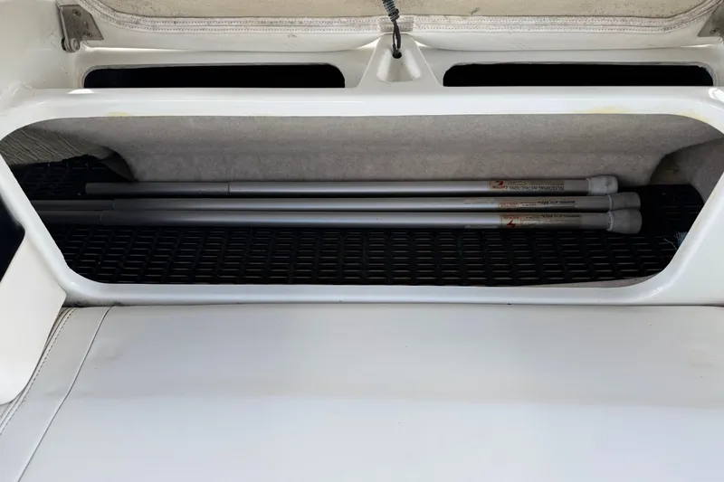 Slide: The Image of Storage compartment of a 2004 Formula 260 Bowrider boat with poles inside. - 28