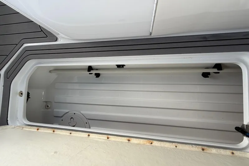 Slide: The Image of Storage compartment of a 2004 Formula 260 Bowrider boat, featuring a sleek interior design. - 29