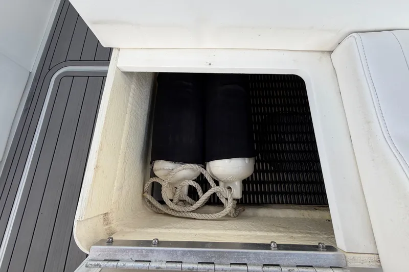 Slide: The Image of Storage compartment on a 2004 Formula 260 Bowrider boat with fenders and ropes. - 34