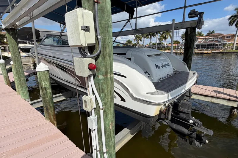 Slide: The Image of 2004 Formula 260 Bowrider boat docked, featuring sleek design and waterfront setting. - 4