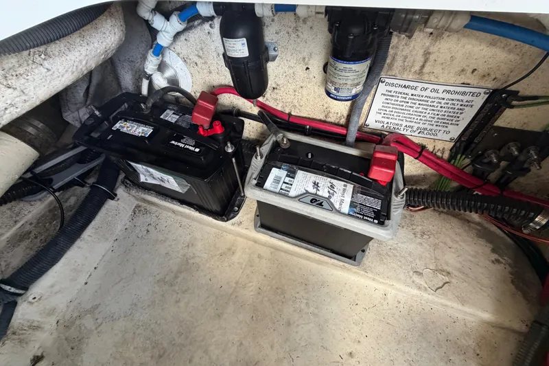 Slide: The Image of 2004 Formula 260 Bowrider boat battery compartment with wiring and warning sign. - 42