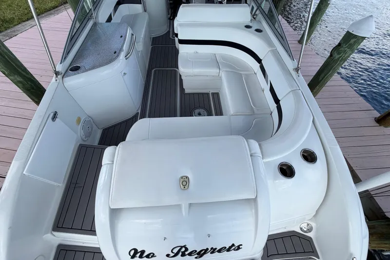 Slide: The Image of 2004 Formula 260 Bowrider boat interior with white seating and "No Regrets" text. - 9