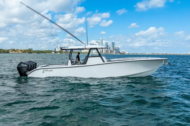 The Image of 2024 Yellowfin 39 Offshore boat cruising on open water with city skyline backdrop. - 0