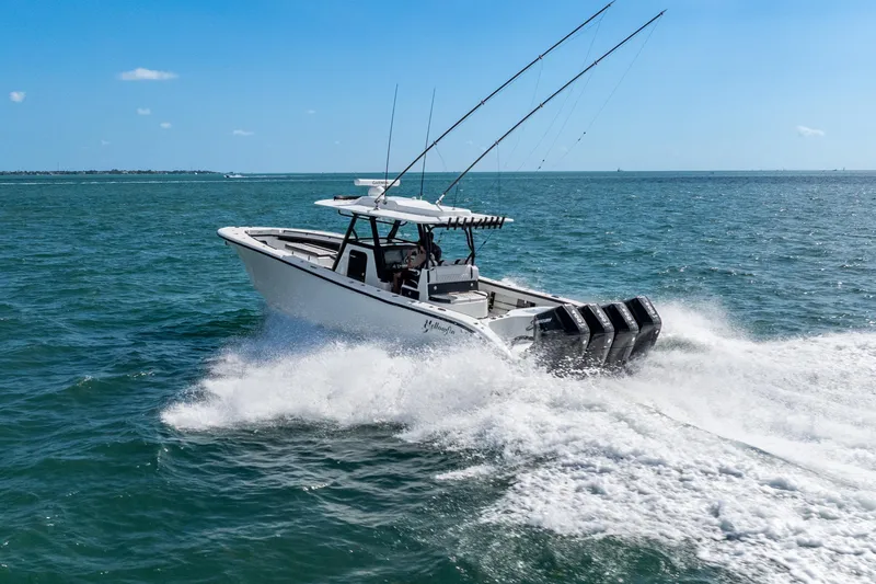 Slide: The Image of 2024 Yellowfin 39 Offshore boat cruising on open water with fishing rods. - 10