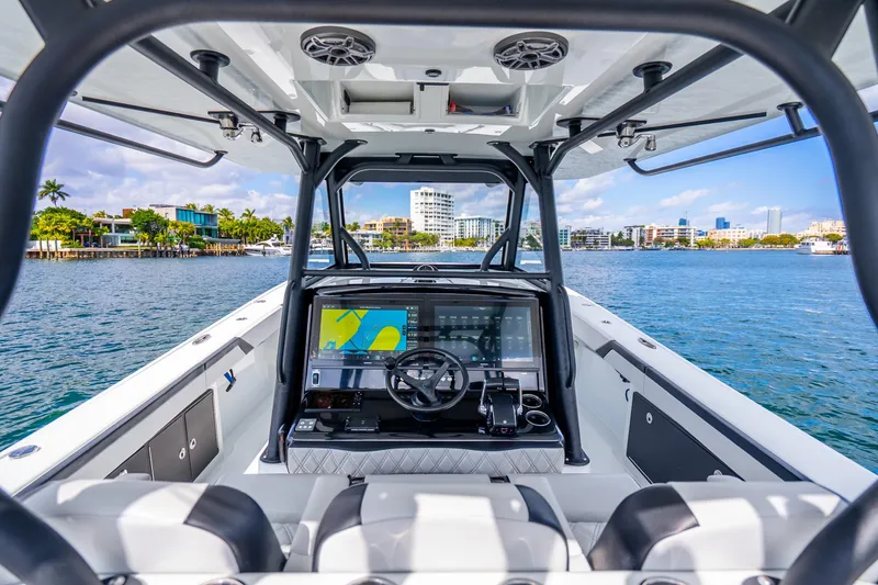 Slide: The Image of 2024 Yellowfin 39 Offshore boat interior with advanced navigation system on a sunny day. - 14