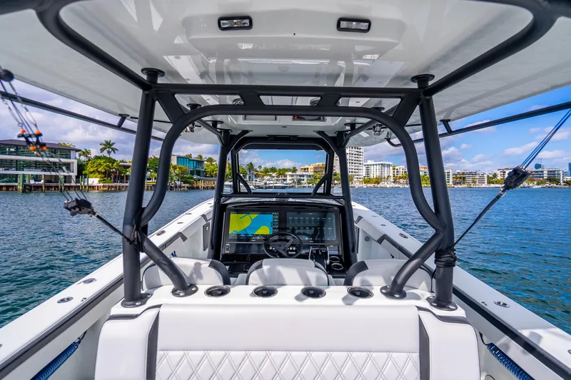 Slide: The Image of 2024 Yellowfin 39 Offshore boat interior with modern navigation system on a sunny day. - 16