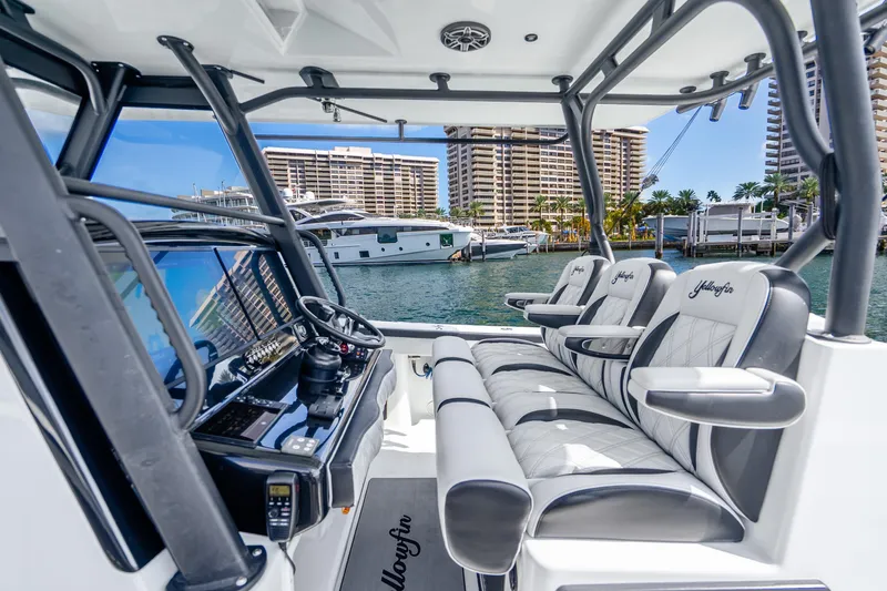 Slide: The Image of 2024 Yellowfin 39 Offshore boat interior with luxury seating and modern controls. - 17