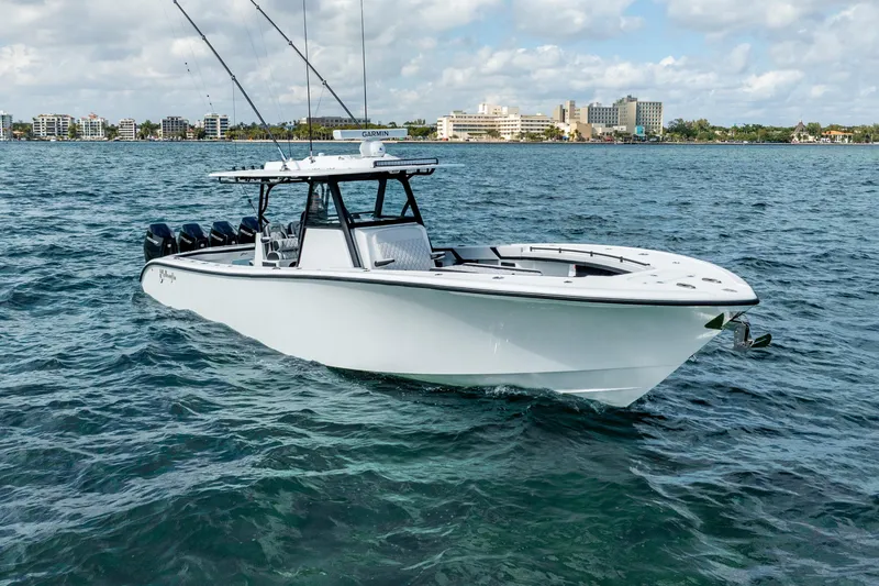 Slide: The Image of 2024 Yellowfin 39 Offshore boat on open water, cityscape in background. - 2