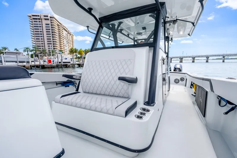 Slide: The Image of 2024 Yellowfin 39 Offshore boat interior with luxurious seating and waterfront view. - 28