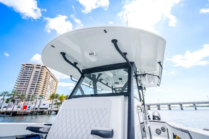 Slide: The Image of 2024 Yellowfin 39 Offshore boat docked, showcasing sleek design under a clear blue sky. - 29