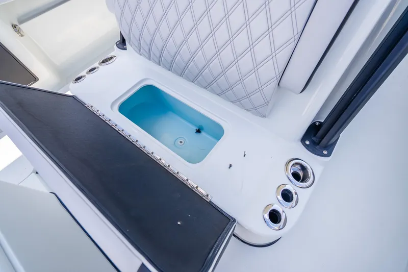 Slide: The Image of 2024 Yellowfin 39 Offshore boat interior with open storage compartment and rod holders. - 30