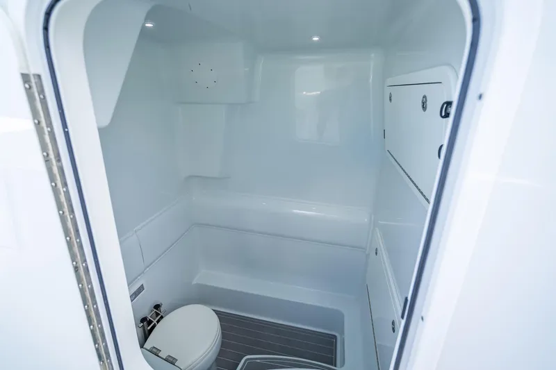 Slide: The Image of 2024 Yellowfin 39 Offshore boat interior bathroom with modern fixtures and white finish. - 35