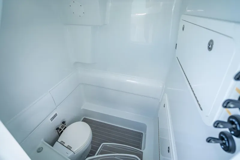 Slide: The Image of 2024 Yellowfin 39 Offshore boat bathroom with modern white interior and compact design. - 36