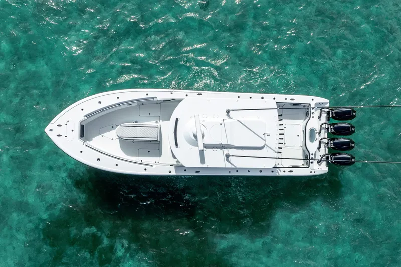 Slide: The Image of 2024 Yellowfin 39 Offshore boat on clear turquoise water, aerial view. - 6