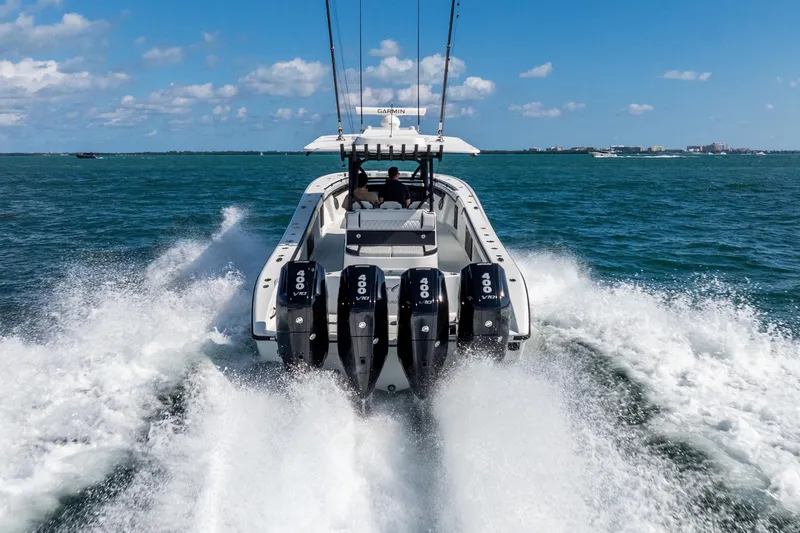 Slide: The Image of 2024 Yellowfin 39 Offshore boat speeding on open water with powerful engines. - 9