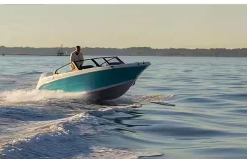 The Image of 2026 Stingray 20 SBX boat cruising on calm water at sunset. - 1