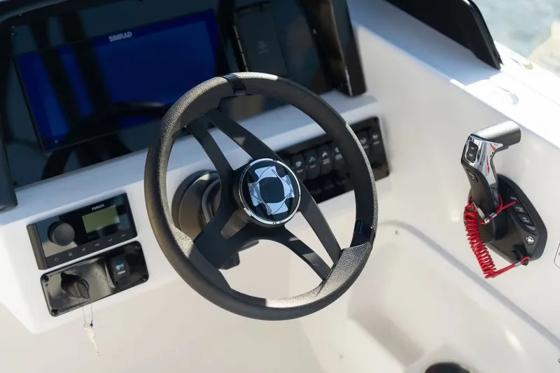 Slide: The Image of Steering wheel and controls of Stingray 20 SBX boat, 2026 model. - 14