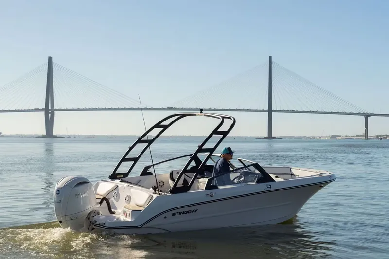 Slide: The Image of 2026 Stingray 20 SBX boat near a bridge. - 3
