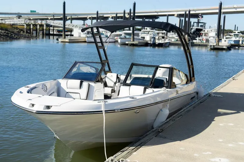 Slide: The Image of 2026 Stingray 20 SBX boat docked on a sunny day. - 6