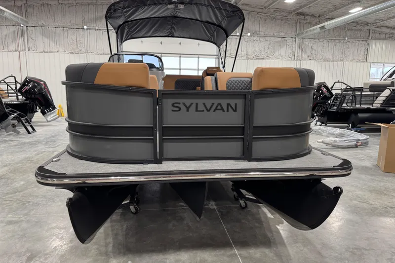 Slide: The Image of 2026 Sylvan L-5 pontoon boat in showroom, featuring sleek design and comfortable seating. - 5